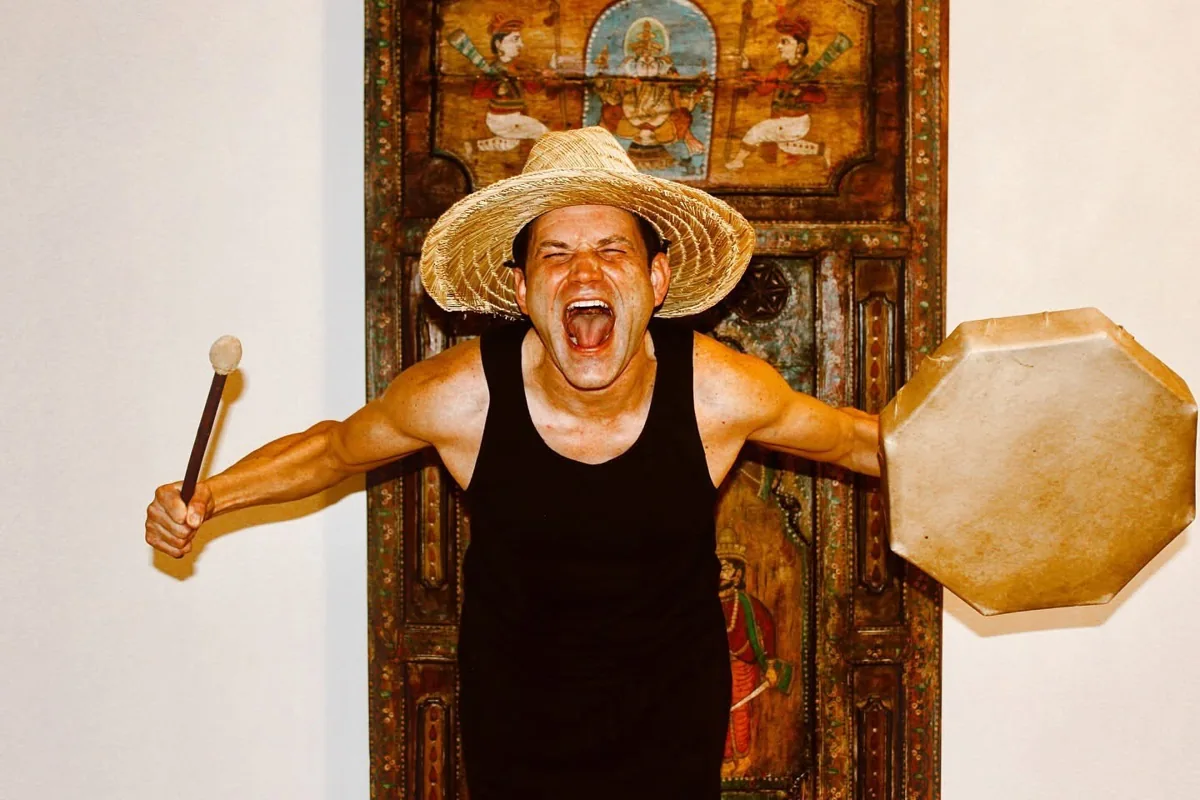 Shawn Lillig holding a frame drum and mallet.