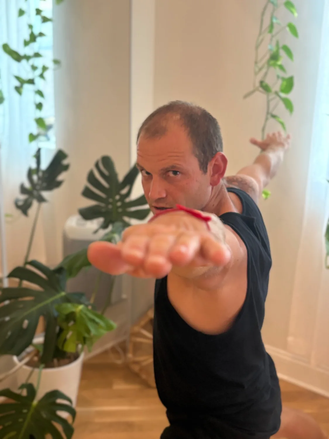 Shawn Lillig extending his arms during yoga practice.