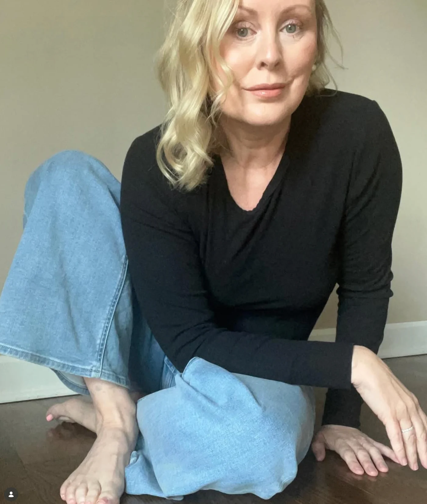 Yvette Smith seated in a black shirt and blue jeans.
